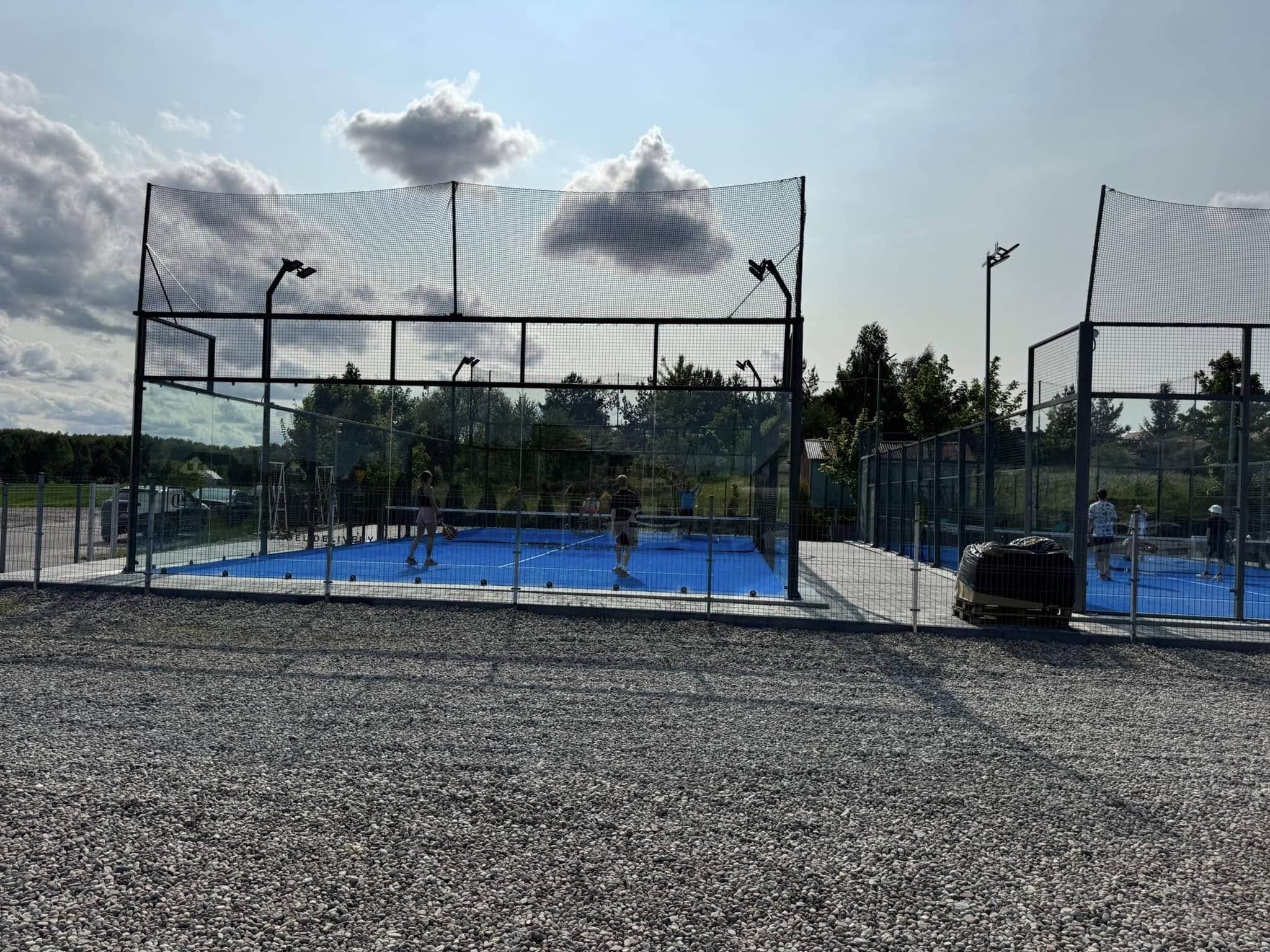 a group of people on a tennis court